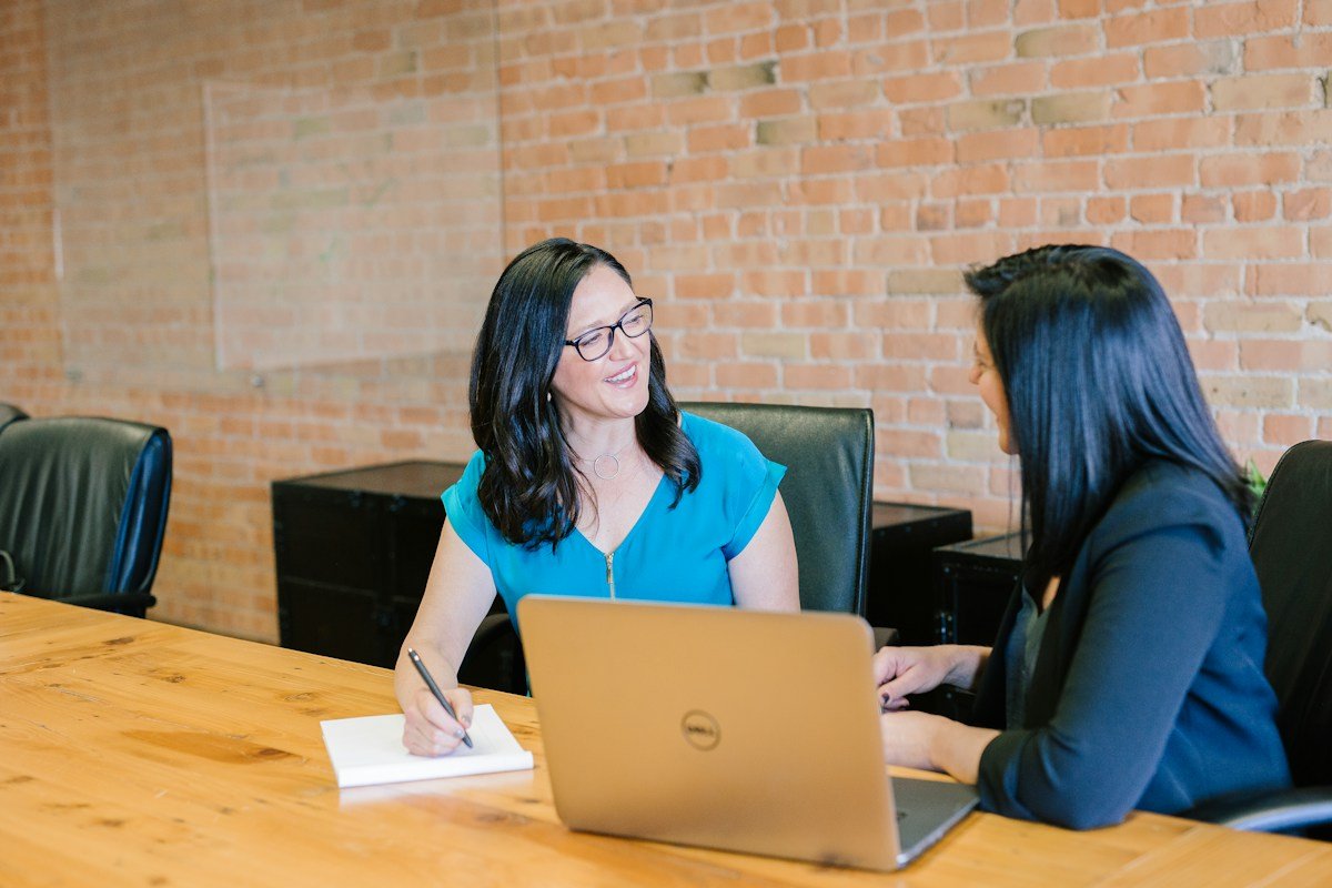 Two professionals coordinating work together